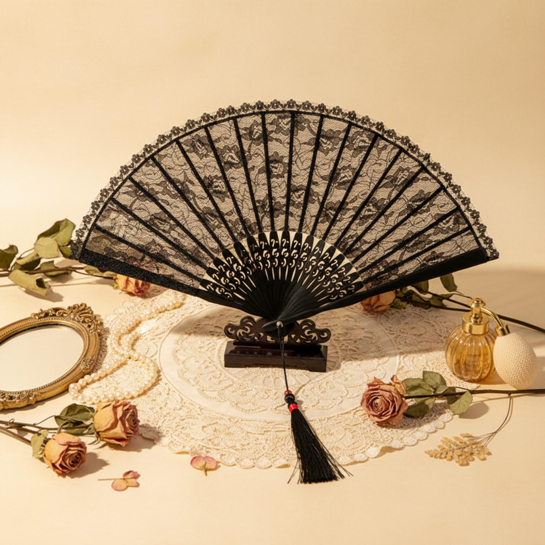 Black lace fan flat lay with jewelry on warm background