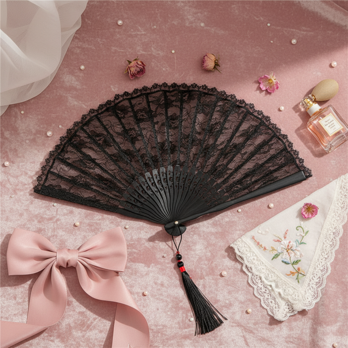 Black lace fan with pink bow on white fabric