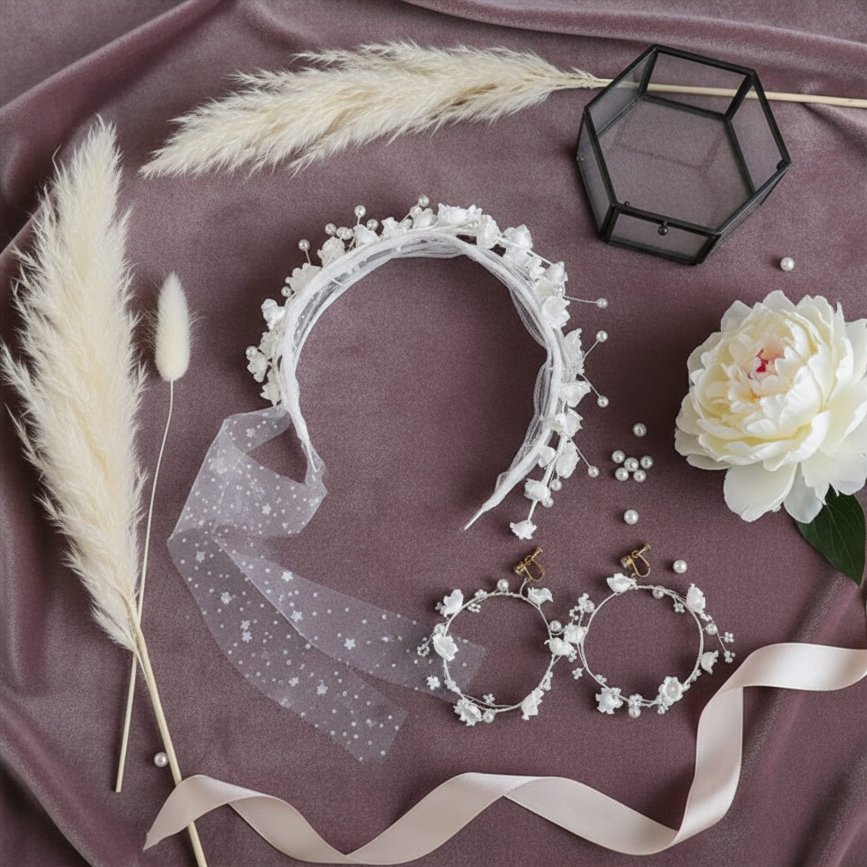 Flower crown headband and hoop earrings flat lay with pampas grass