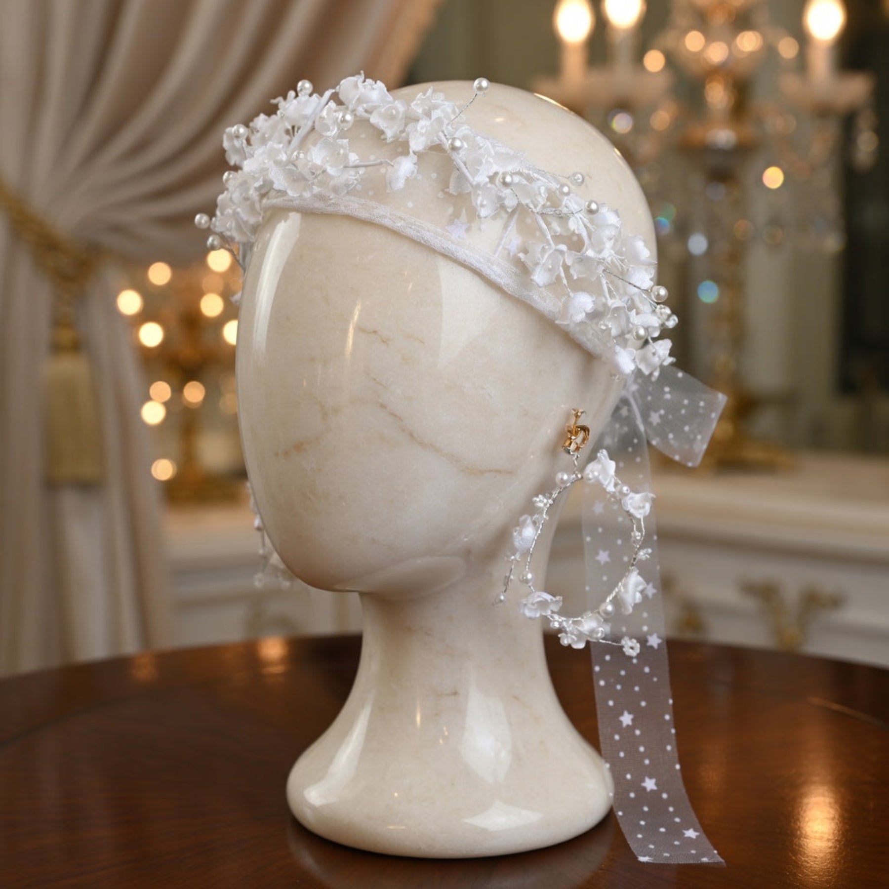 White flower crown bridal headband on mannequin head with ivory curtain