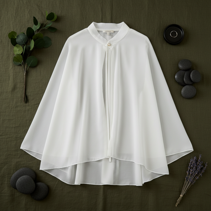 White chiffon poncho cape flat lay with seashells