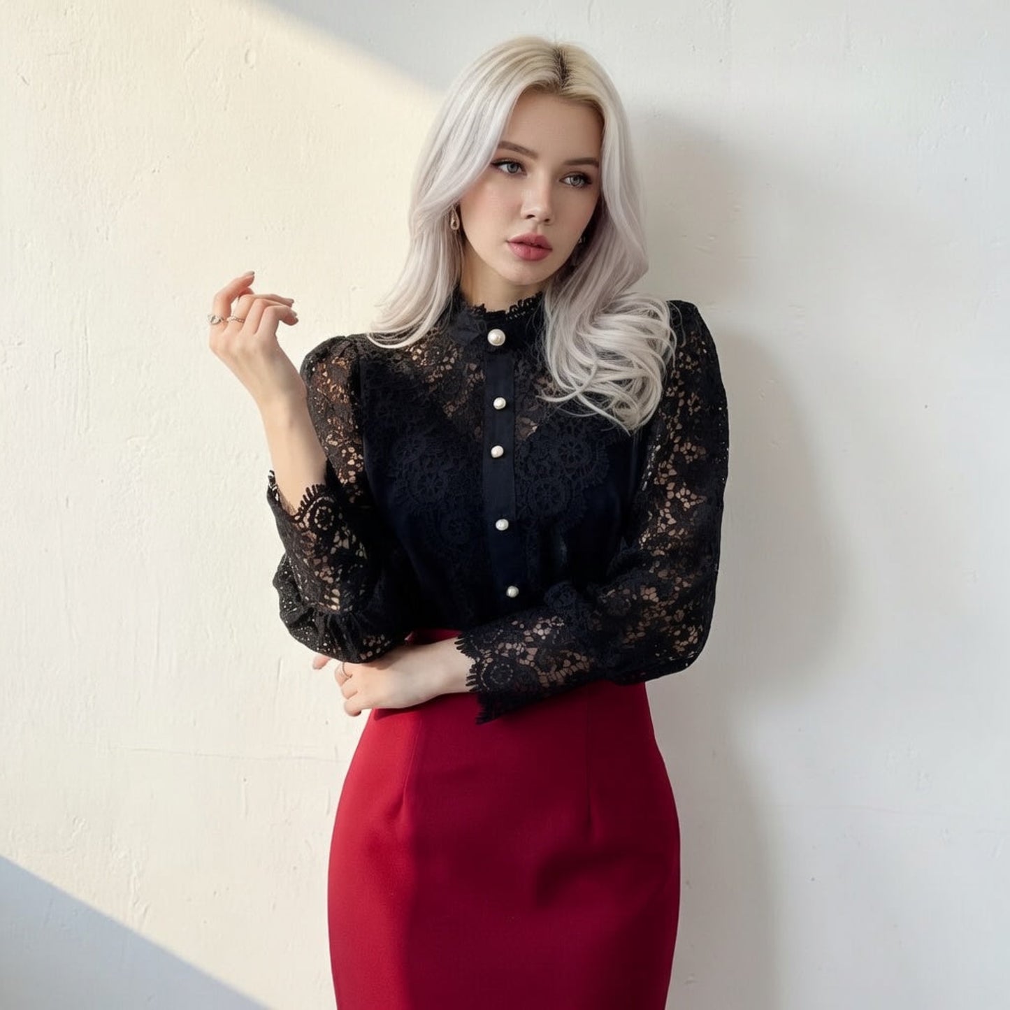 Woman wearing black crochet lace blouse with red skirt