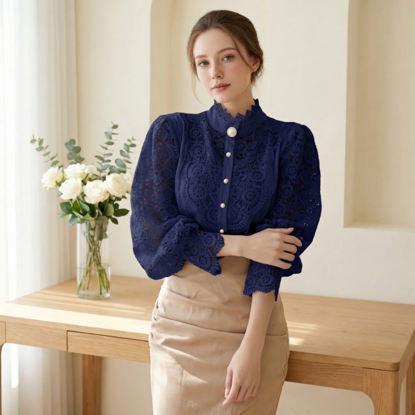 Woman wearing navy blue crochet lace blouse by console table
