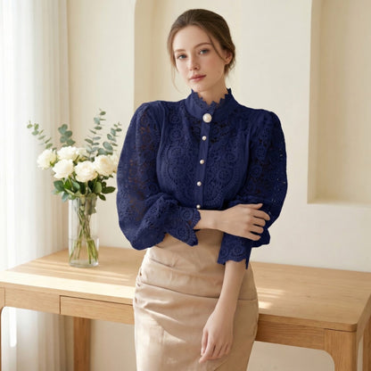 Woman wearing navy blue crochet lace blouse by console table