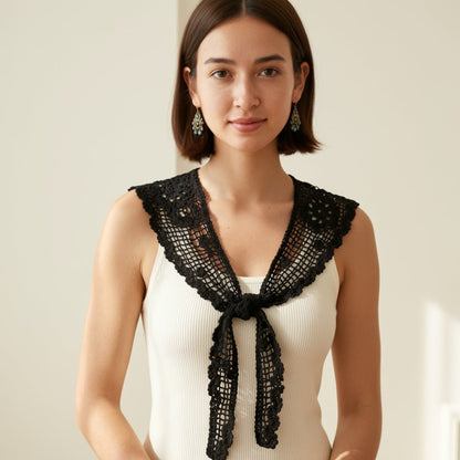 Woman wearing black crochet lace shawl collar over beige top