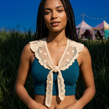 Woman wearing crochet lace shawl over teal top