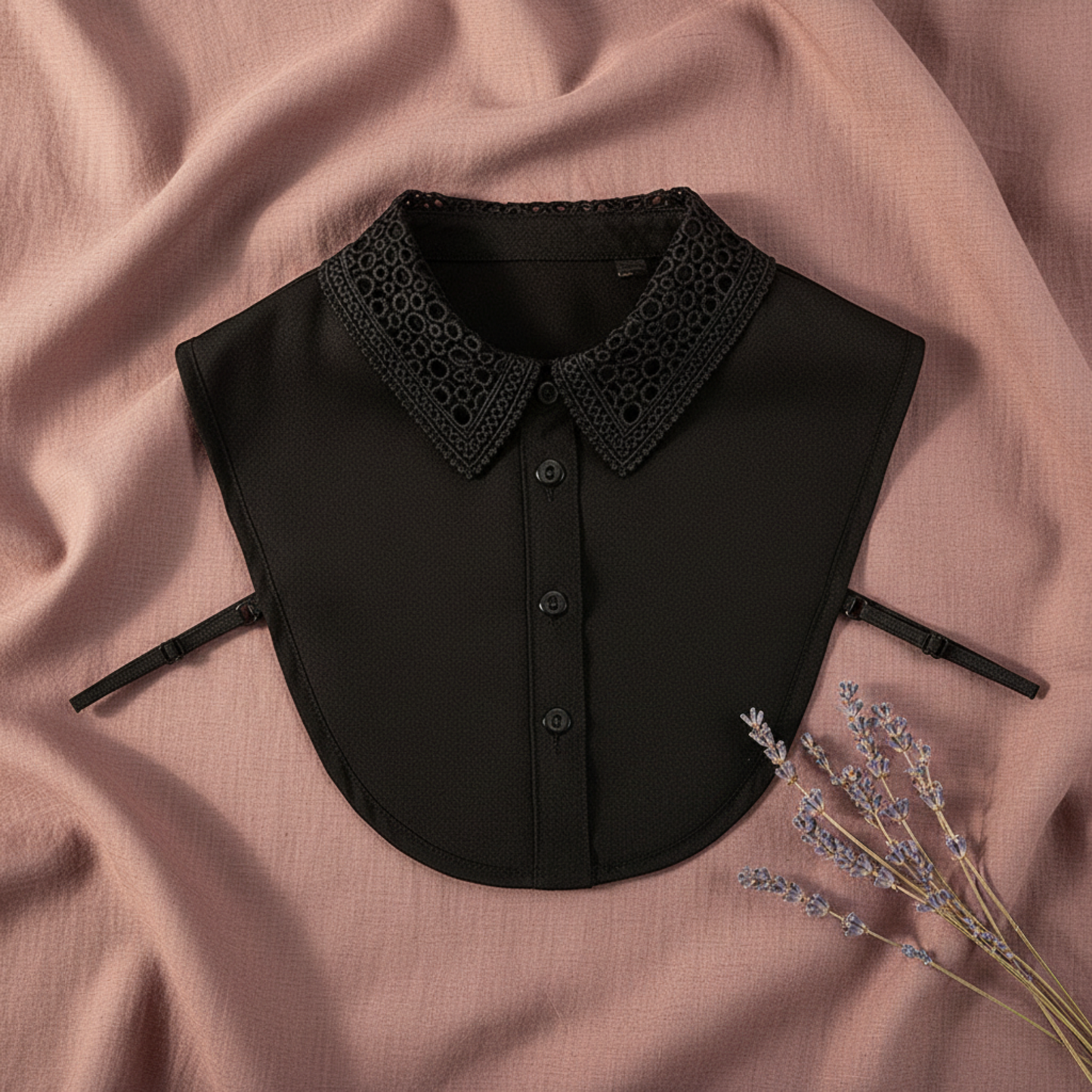 Black lace detachable collar close-up on pink fabric