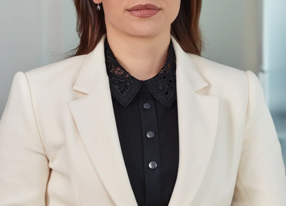 Woman wearing black lace collar over white blazer