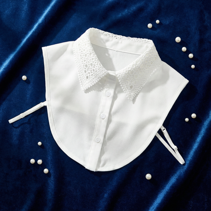 White and navy detachable lace collars flat lay on blue velvet