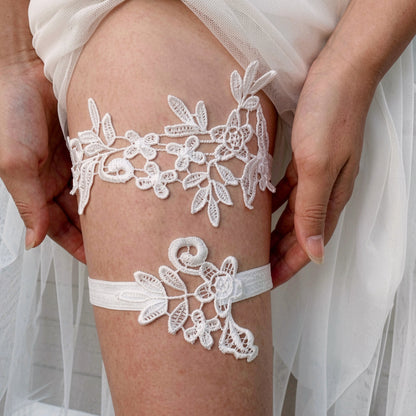 White lace bridal garter worn on leg with wedding veil