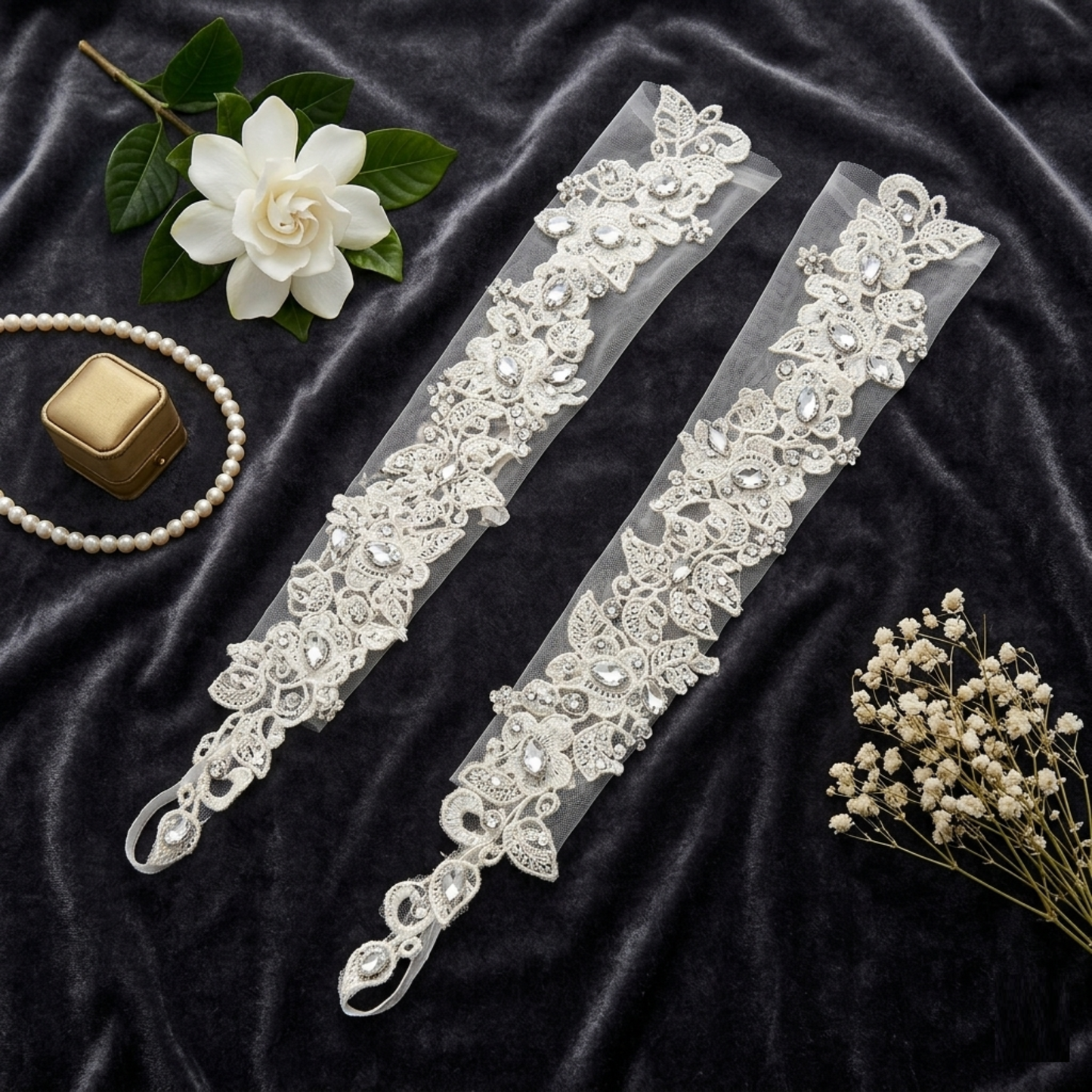 Pair of ivory lace bridal gloves flat lay with floral wedding accessories