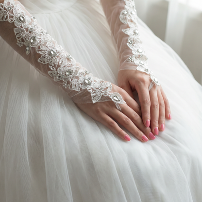 Ivory lace bridal gloves close-up with hands clasped over wedding veil