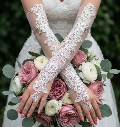 Ivory lace bridal gloves with rhinestone crystals crossed over wedding bouquet