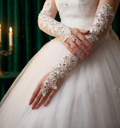Bride's hand in white dress wearing rhinestone-embellished lace glove