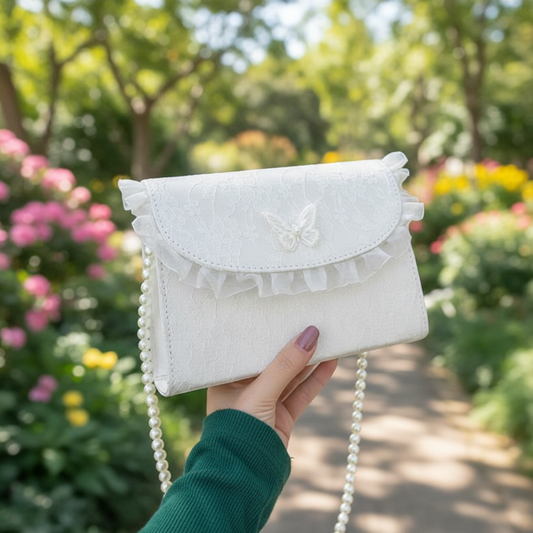 Woman holding white lace crossbody bag on garden path