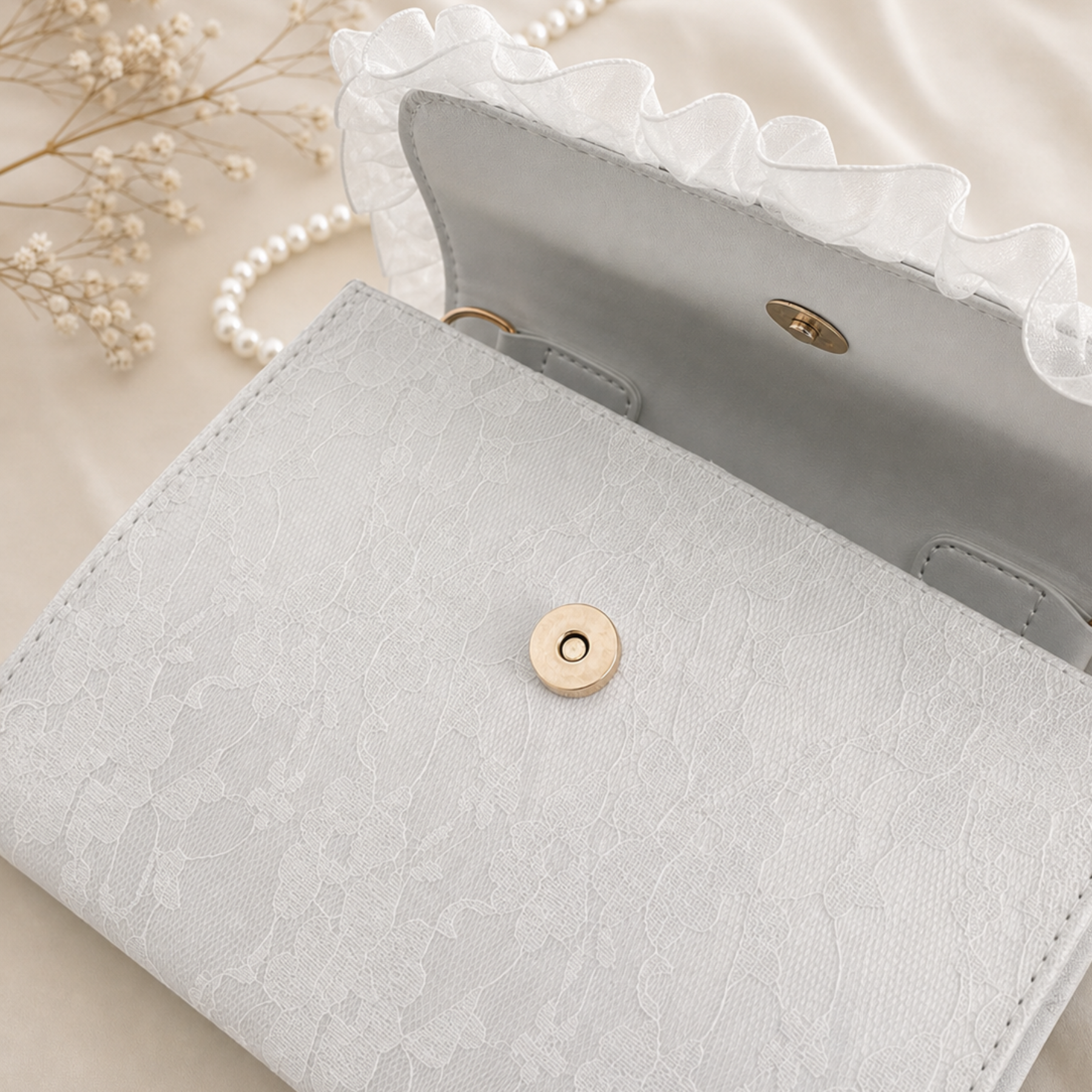 White lace crossbody bag open flap showing gold snap interior