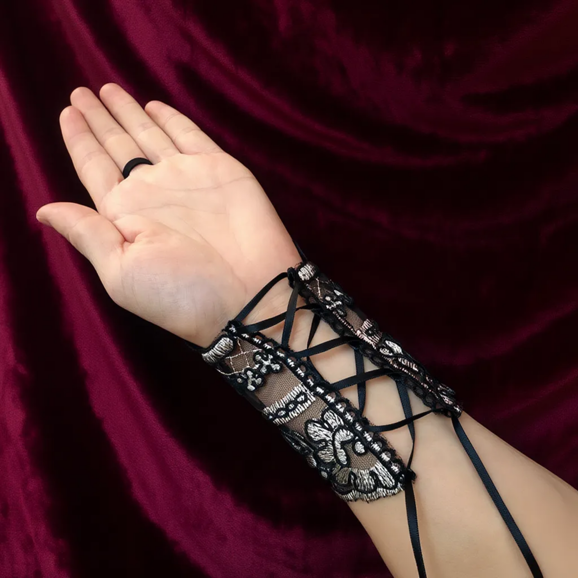 Black lace fingerless glove with lace-up wrist cuff detail