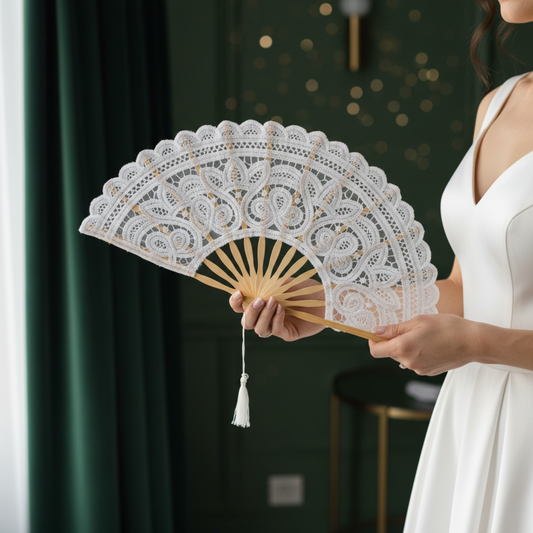 Woman holding white lace hand fan wearing green dress