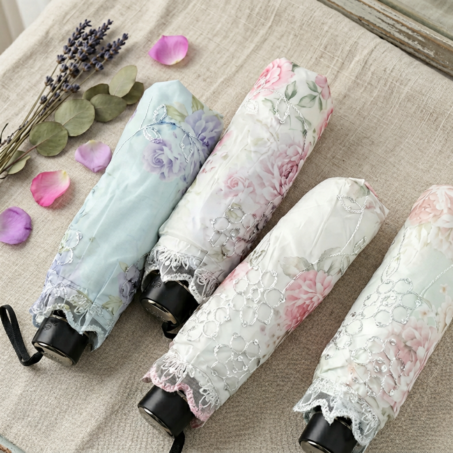 Floral lace parasol umbrellas shown in multiple colors