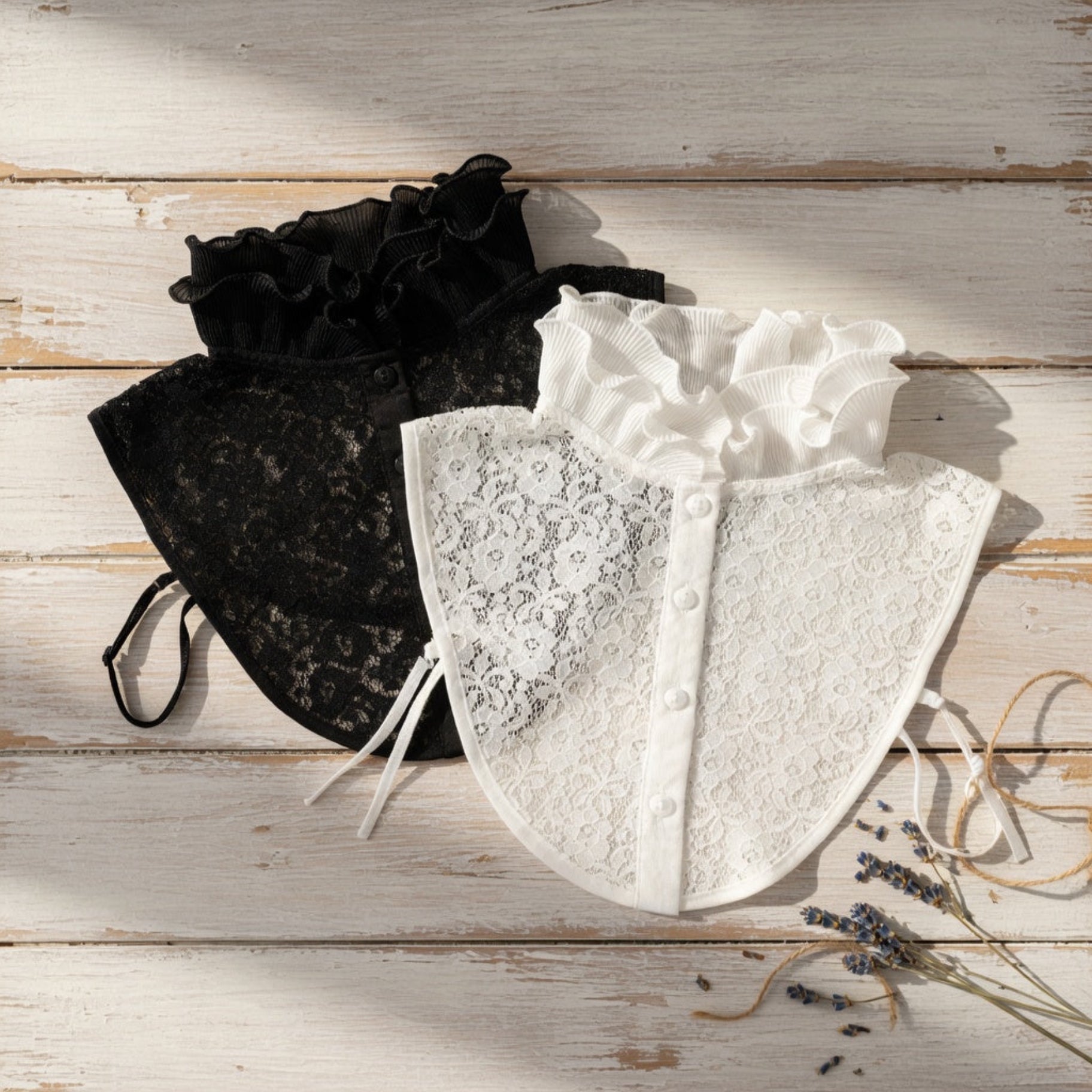 Black and white lace ruffle collars on mannequins side by side