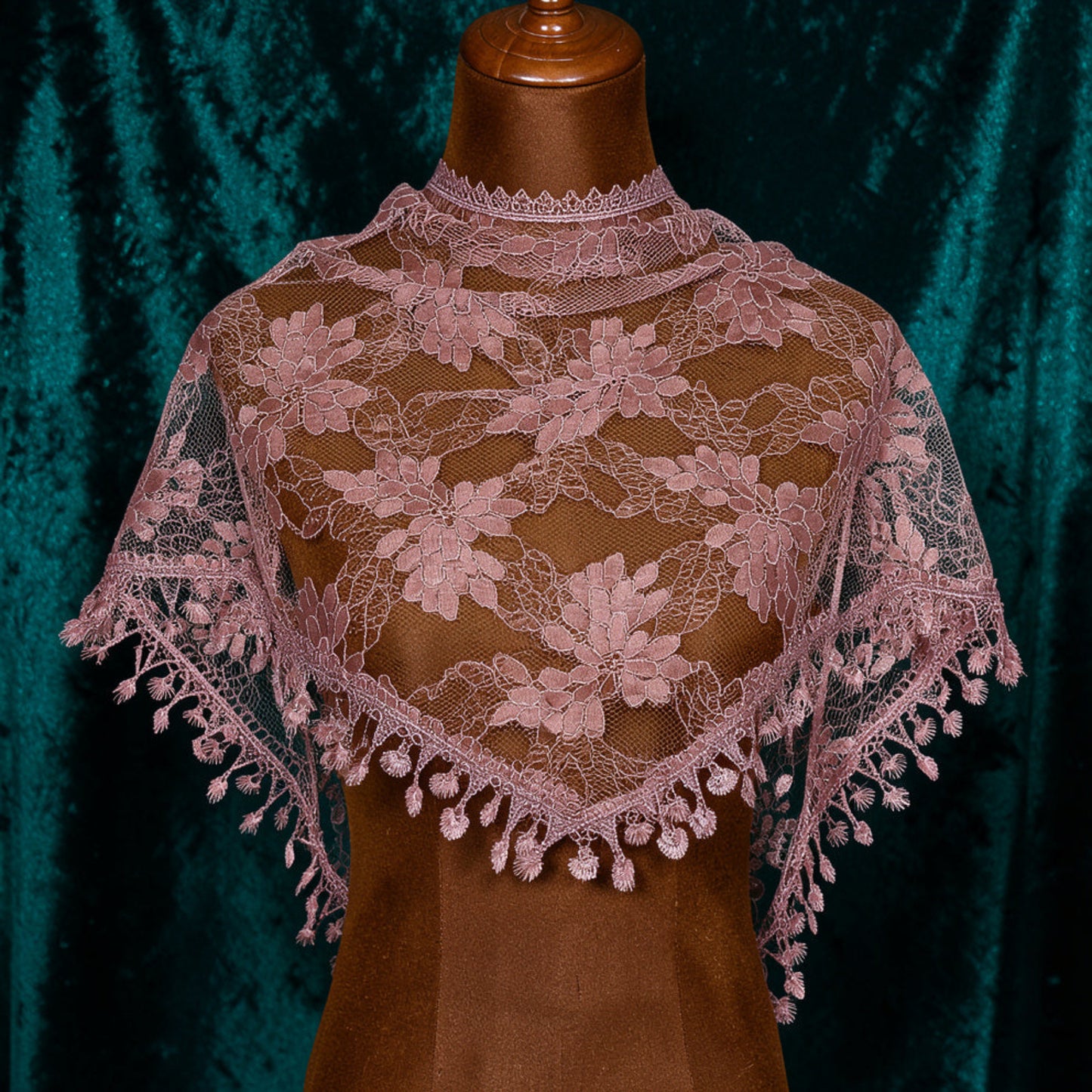 Dusty rose lace triangle scarf on mannequin with teal velvet background