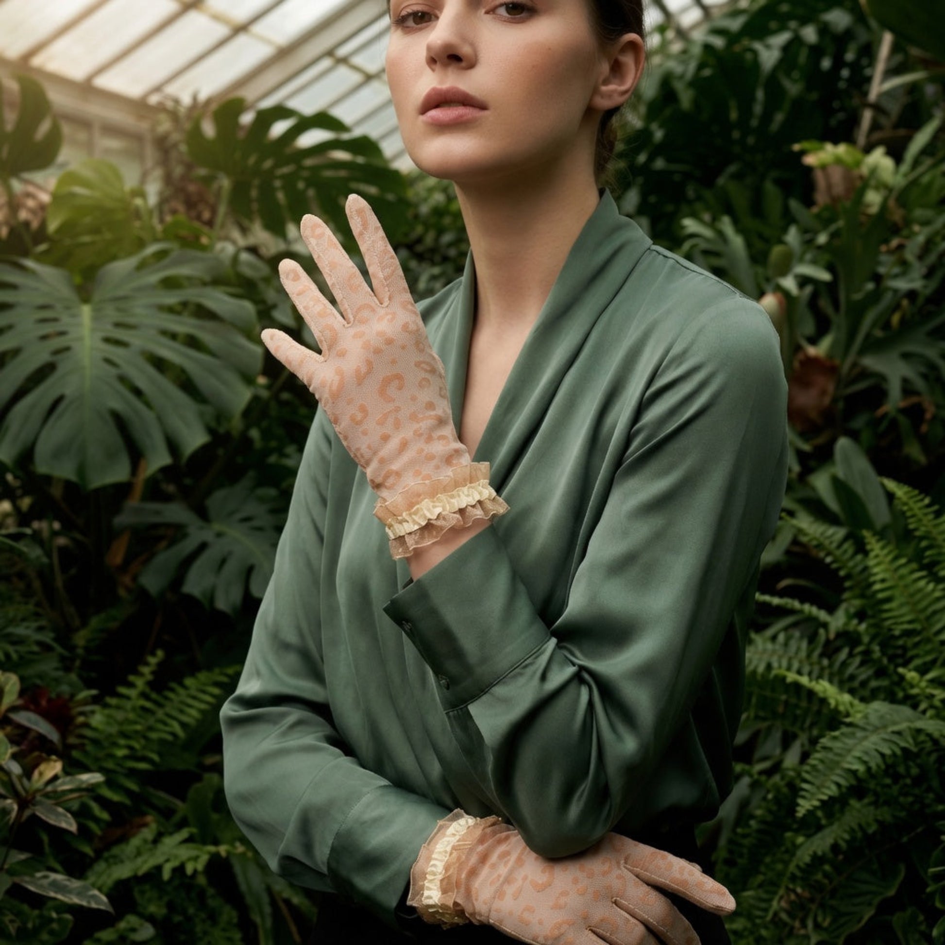 Woman in greenhouse wearing black leopard print lace gloves, close-up