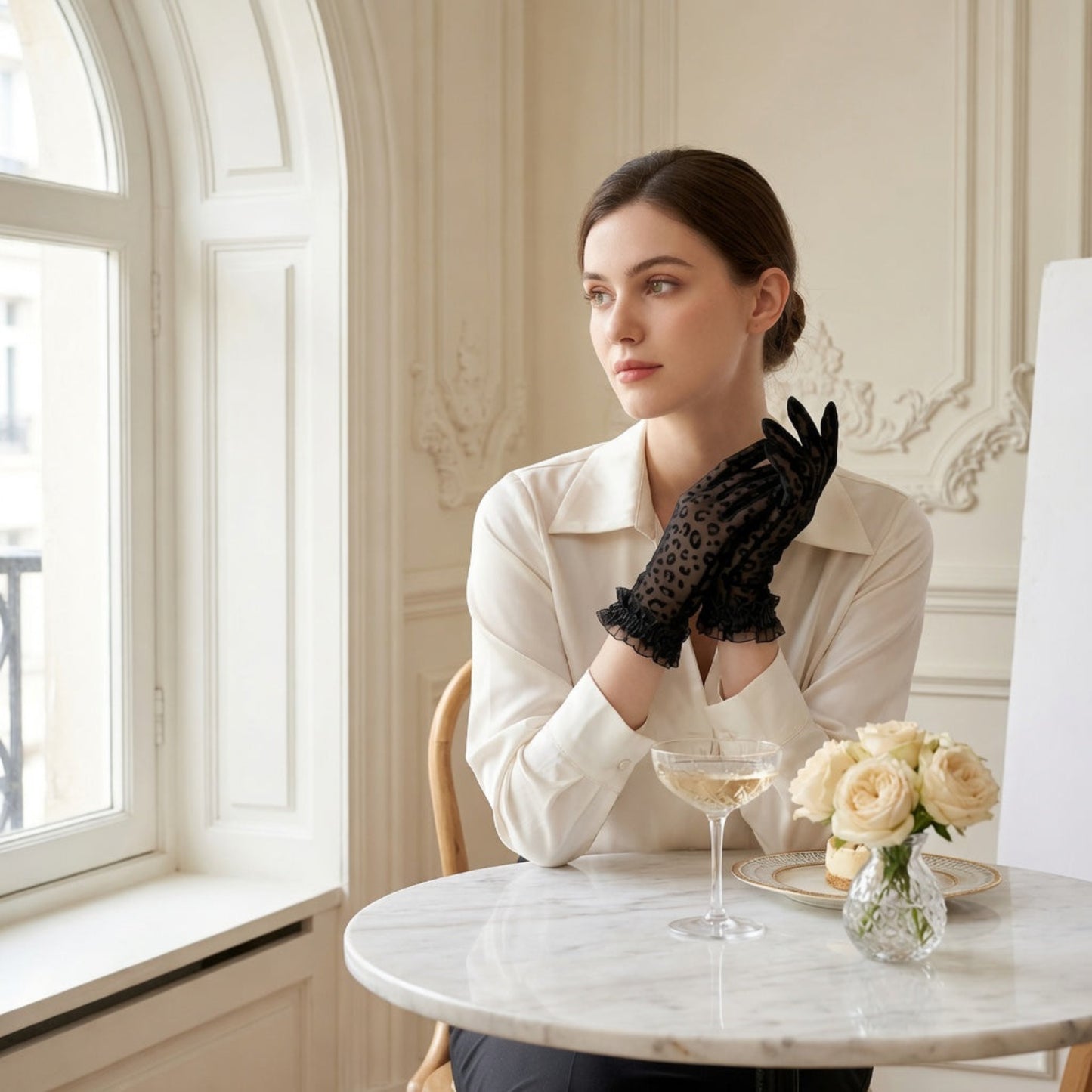 Woman at window table wearing black leopard print lace gloves