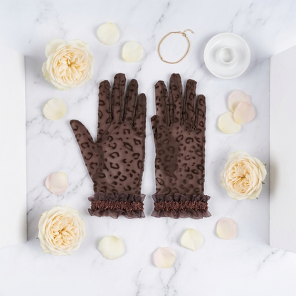 Coffee brown leopard print lace gloves flat lay with white roses