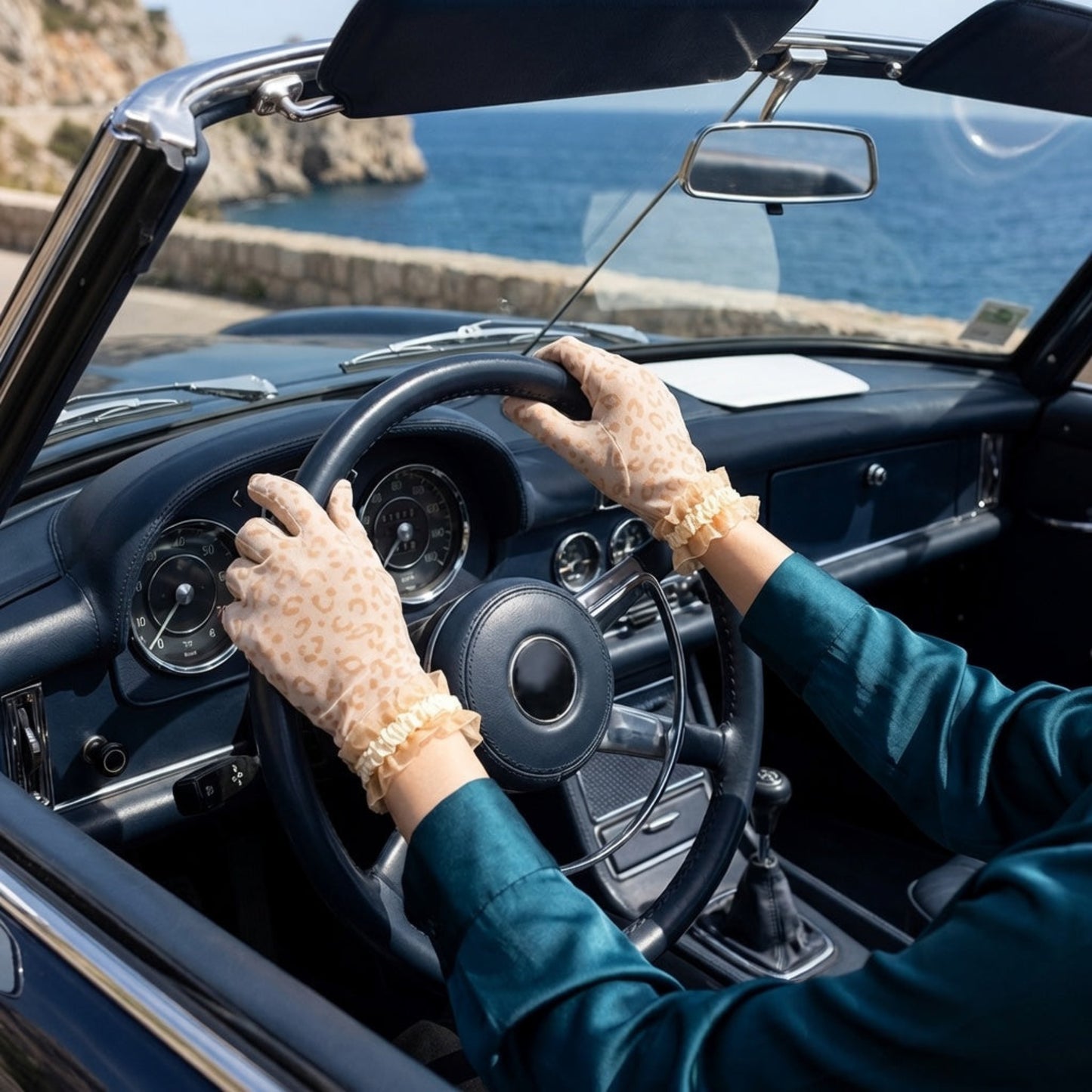 Nude leopard print lace gloves worn while driving a vintage car