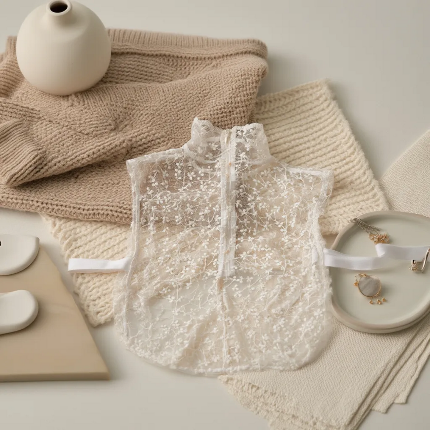 Beige floral lace Peter Pan collar flat lay with knit fabric