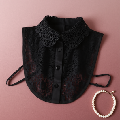 Black lace Peter Pan collar flat lay on pink fabric with pearls