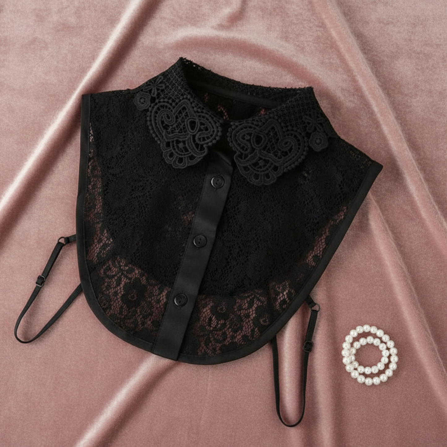 Black lace Peter Pan collar flat lay on pink fabric with ring