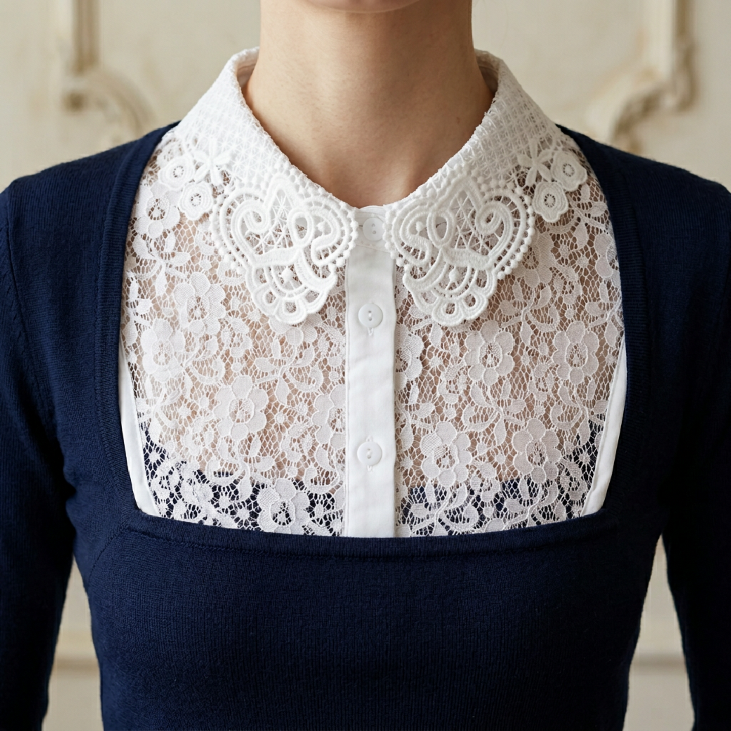 Woman wearing white lace Peter Pan collar with navy dress