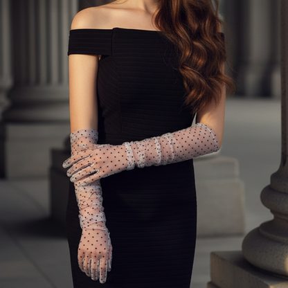 Black polka dot lace opera gloves close-up against column backdrop