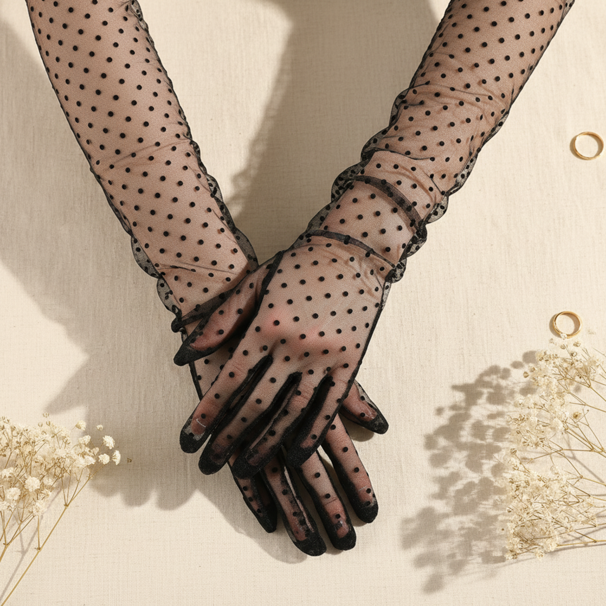 Close-up polka dot lace gloves with clasped hands on ivory background