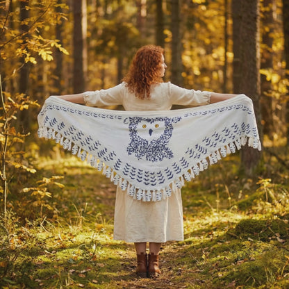 Video of woman wearing snowy owl wings shawl with wingspan movement