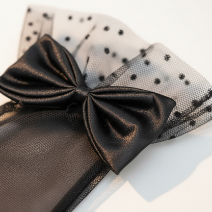 Black sheer mesh bow glove with polka dot lace cuff, flat lay