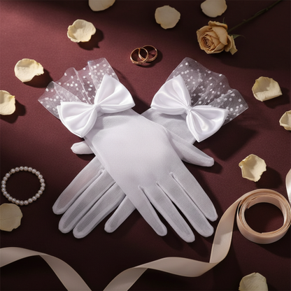 White sheer mesh bow gloves flat lay with dried roses and ribbon