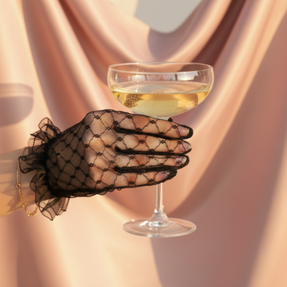 Black lace bridal glove toasting with a glass of wine