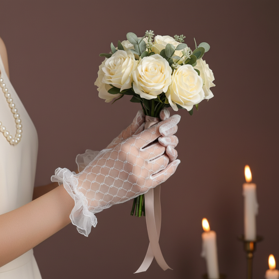 White lace bridal glove holding a wedding bouquet with candles