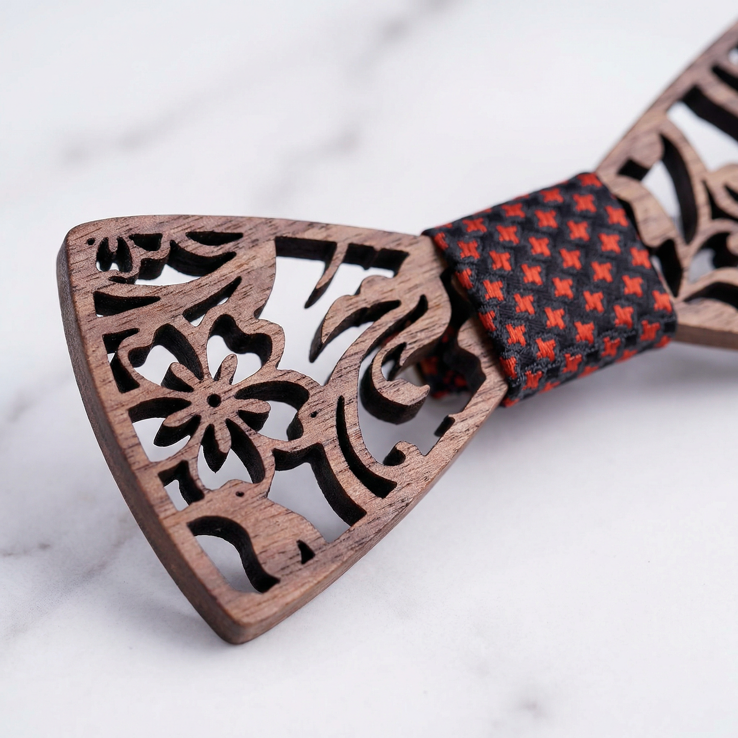 Walnut floral bow tie detail on white marble surface