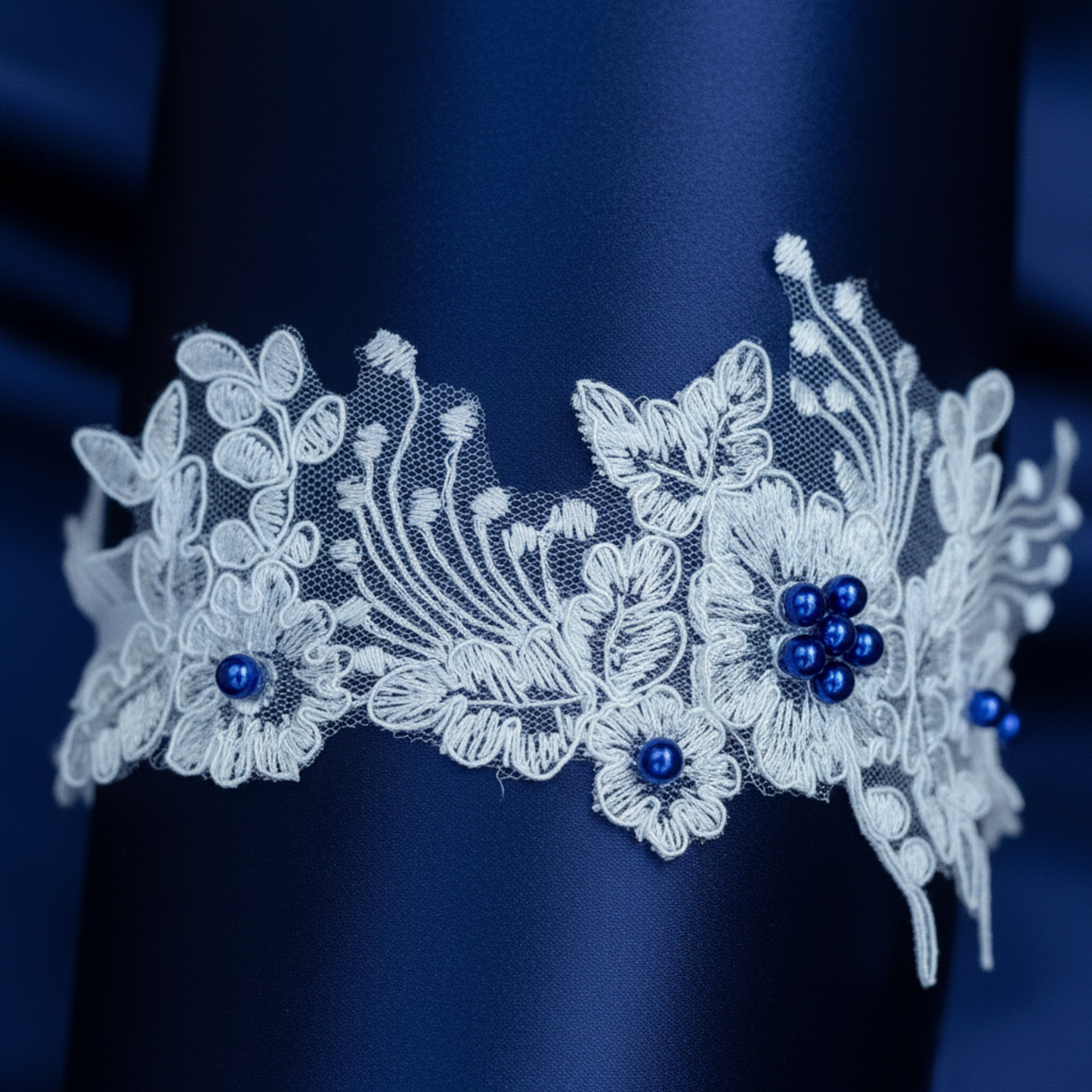 Navy blue floral lace wedding garter flat lay