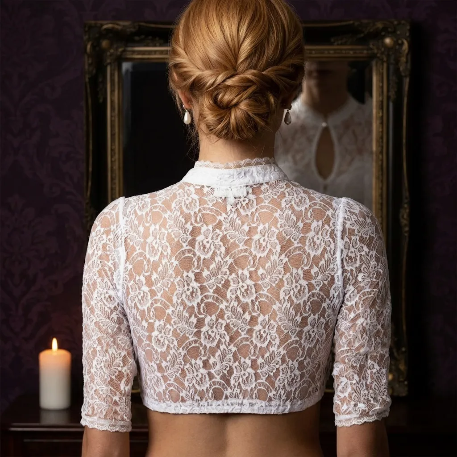 Back view of white lace crop top with hair bun by candlelight
